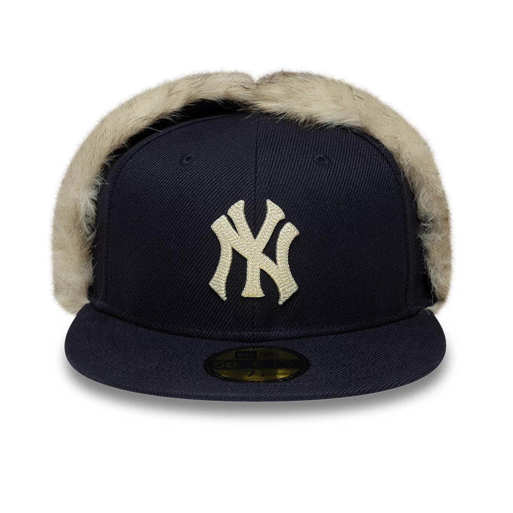 New York Yankees MLB Cotton Canvas Navy Dogear New Era 59FIFTY Fitted Cap, front view showing the raised gold embroidered NY logo on the structured navy crown, with beige faux fur lining around the ears.