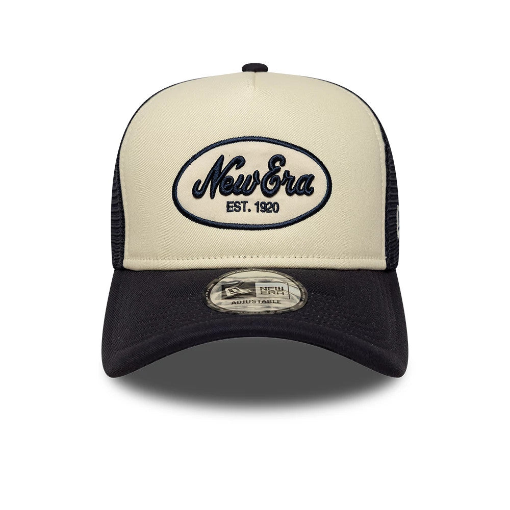 New Era Oval Patch Black New Era 9FORTY A-Frame Trucker Adjustable Cap, front view showing the embroidered blue New Era logo within an oval patch on the cream front panel, with a black curved visor and a 9FORTY size sticker.
