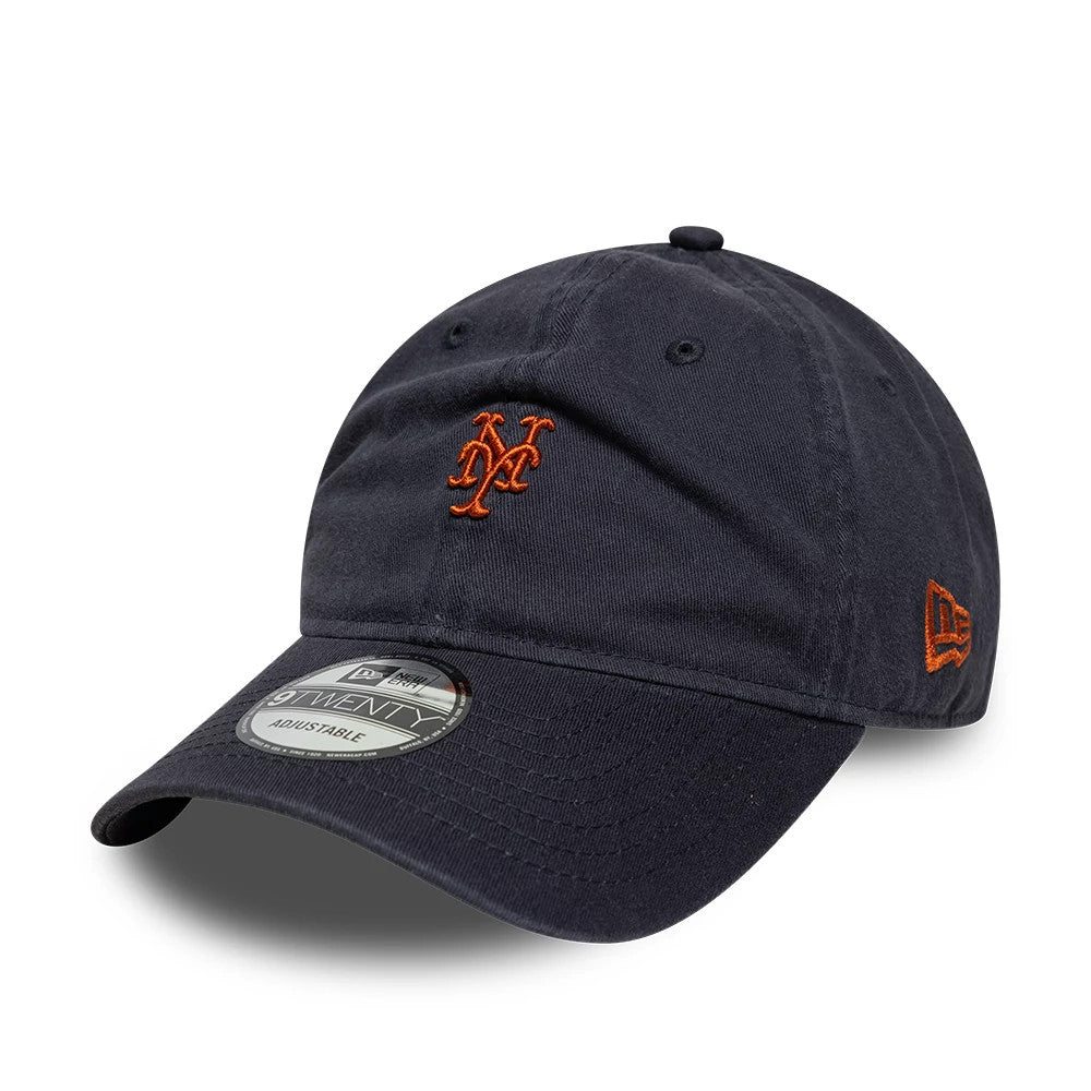 New York Mets MLB Mini Logo Navy New Era 9TWENTY Adjustable Cap, three-quarter view showing the orange embroidered Mets logo on the front panel, curved navy visor with a 9TWENTY size sticker, and New Era flag logo on the left side.