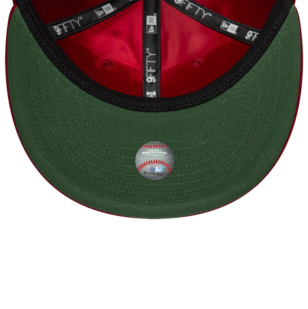Phillies MLB Heritage Dark Red Retro Crown New Era 9FIFTY Adjustable Cap, inside view showing a green undervisor with an MLB baseball holographic sticker, black sweatband with white branding, and red inner crown lining with black taping.