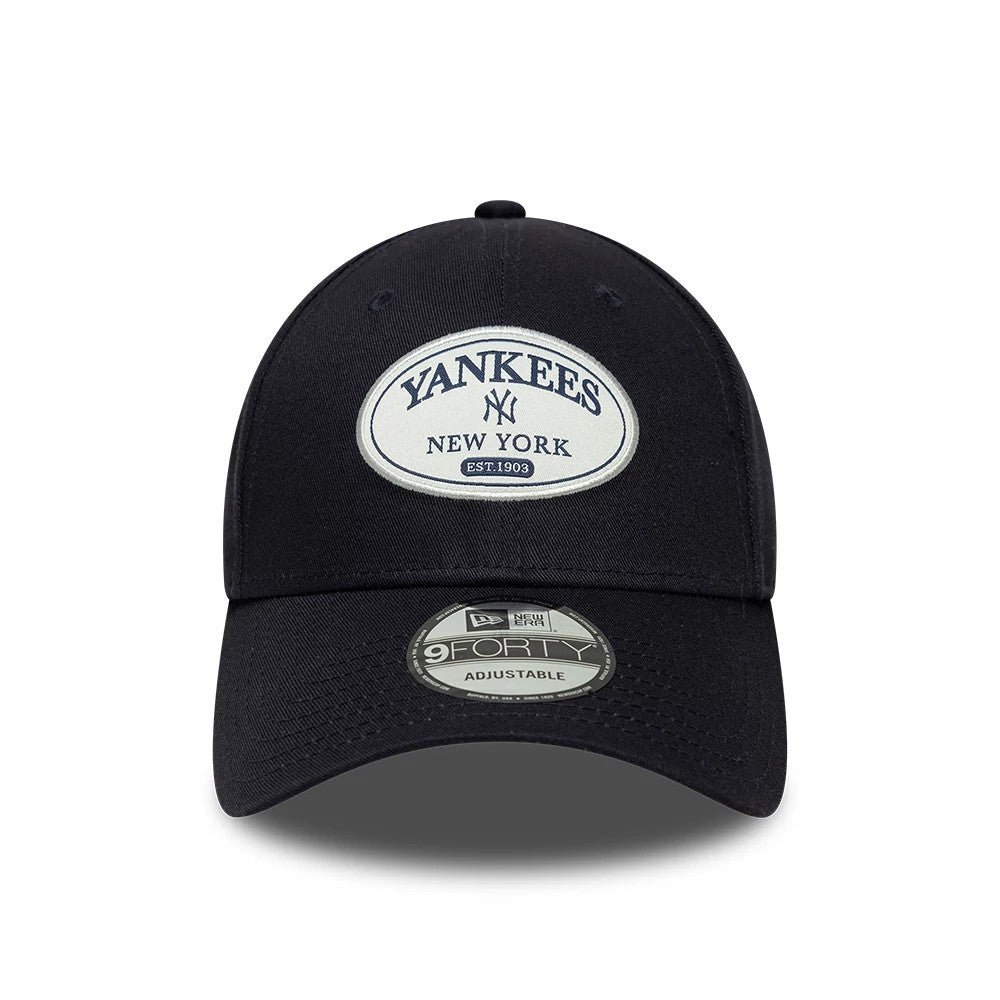 New York Yankees MLB Patch Navy New Era 9FORTY Adjustable Cap, front view showing an embroidered oval patch with Yankees New York in navy, centred on the structured front panel, and a 9FORTY size sticker on the curved visor.