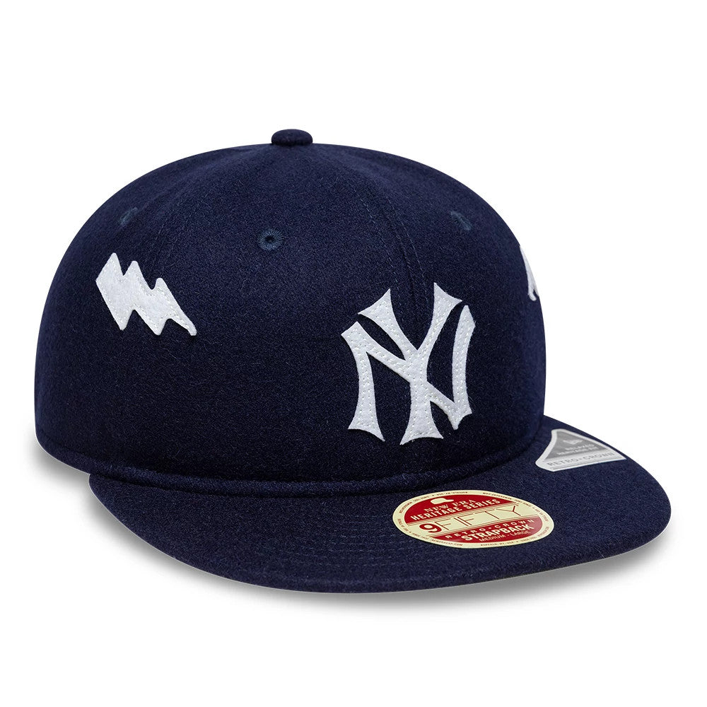 New York Yankees MLB Heritage Navy Retro Crown New Era 9FIFTY Adjustable Cap, three-quarter view showing the raised white NY logo on the front panel, a rounded visor with a red 9FIFTY size sticker, and white side graphics on the structured crown.