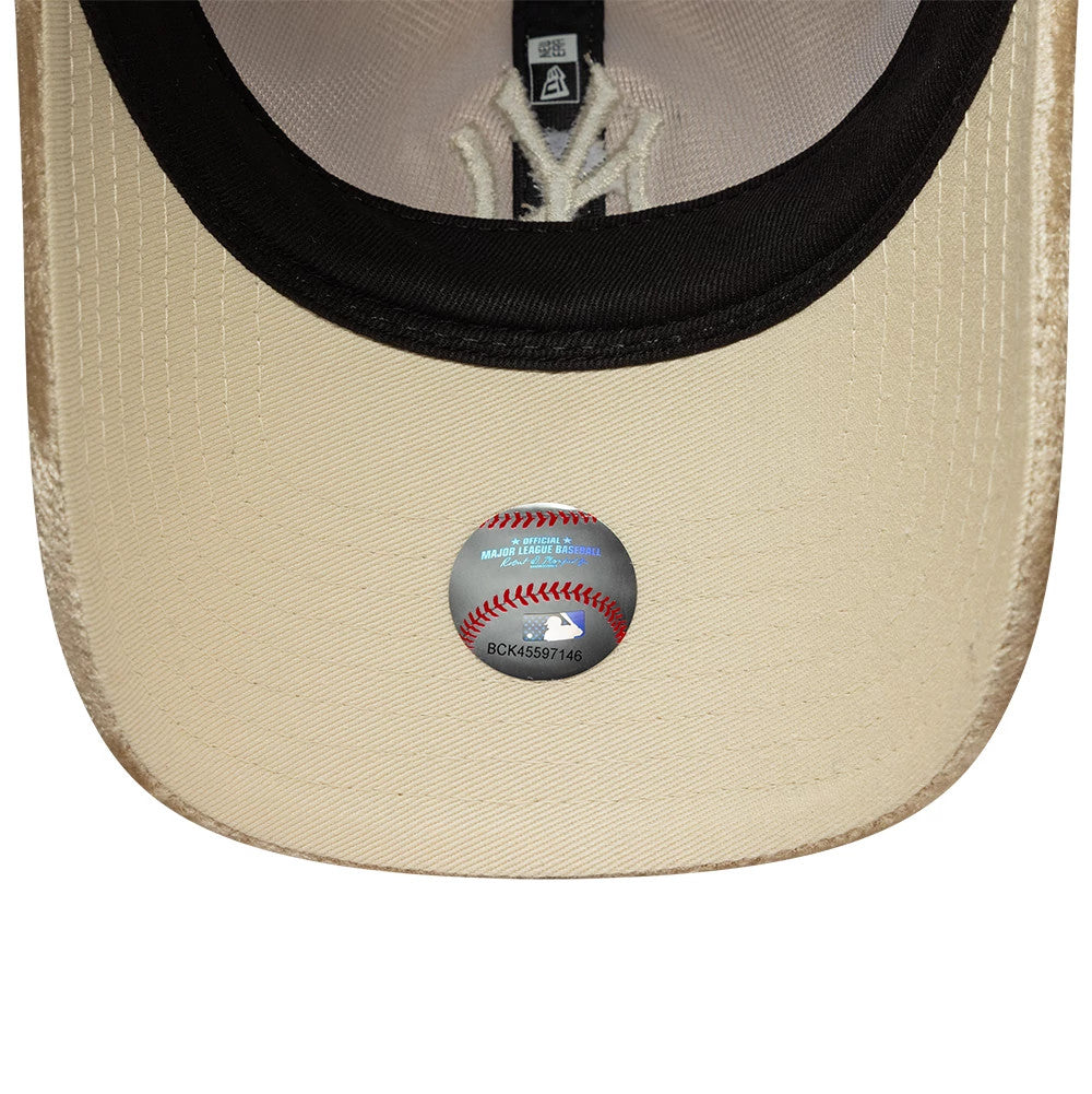 New York Yankees Womens MLB Velour Beige New Era 9TWENTY Adjustable Cap, inside view showing the black sweatband, white taping, and beige undervisor with an MLB sticker featuring a baseball design at the centre.