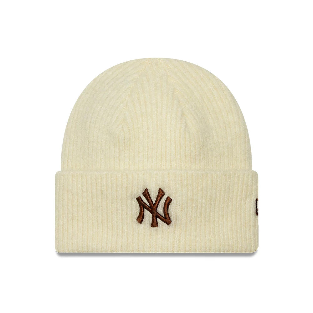 New Era New York Yankees Womens MLB Wide Cream Cuff Knit Beanie Hat, front view showing the brown embroidered NY logo on the wide cream-coloured cuff, distinct ribbed knit texture on the crown, and small brown New Era flag logo on the side.