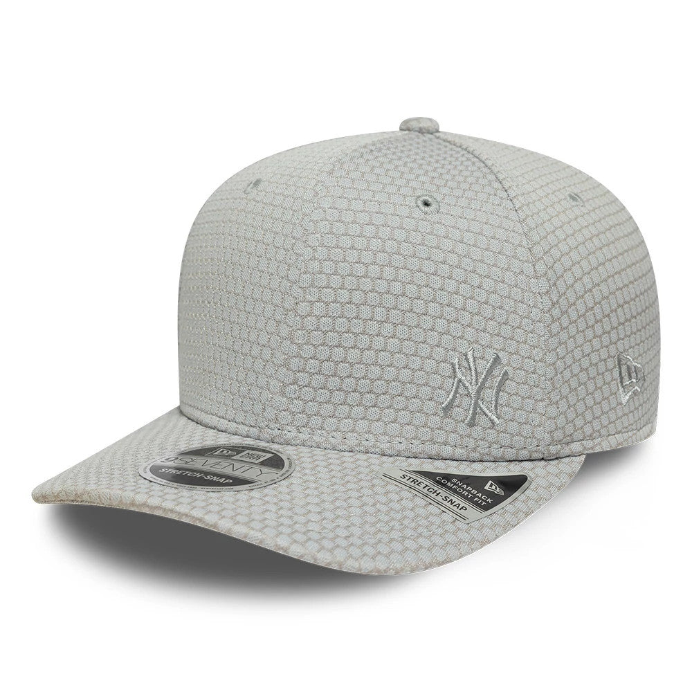 Yankees MLB Flawless Mesh Grey New Era 9SEVENTY Stretch Snap Adjustable Cap, three-quarter view showing the grey embroidered Yankees logo on the front panel, the curved grey visor with a 9SEVENTY size sticker.