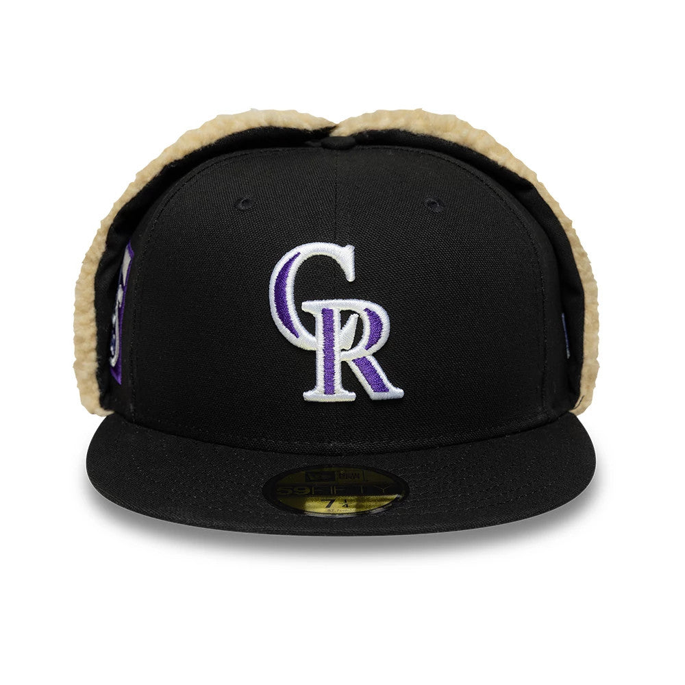 Colorado Rockies MLB World Series Black Dogear New Era 59FIFTY Fitted Cap, front view showing the raised purple and white embroidered CR logo on the front panel, a black flat visor with a gold 59FIFTY size sticker, and tan dogear lining.