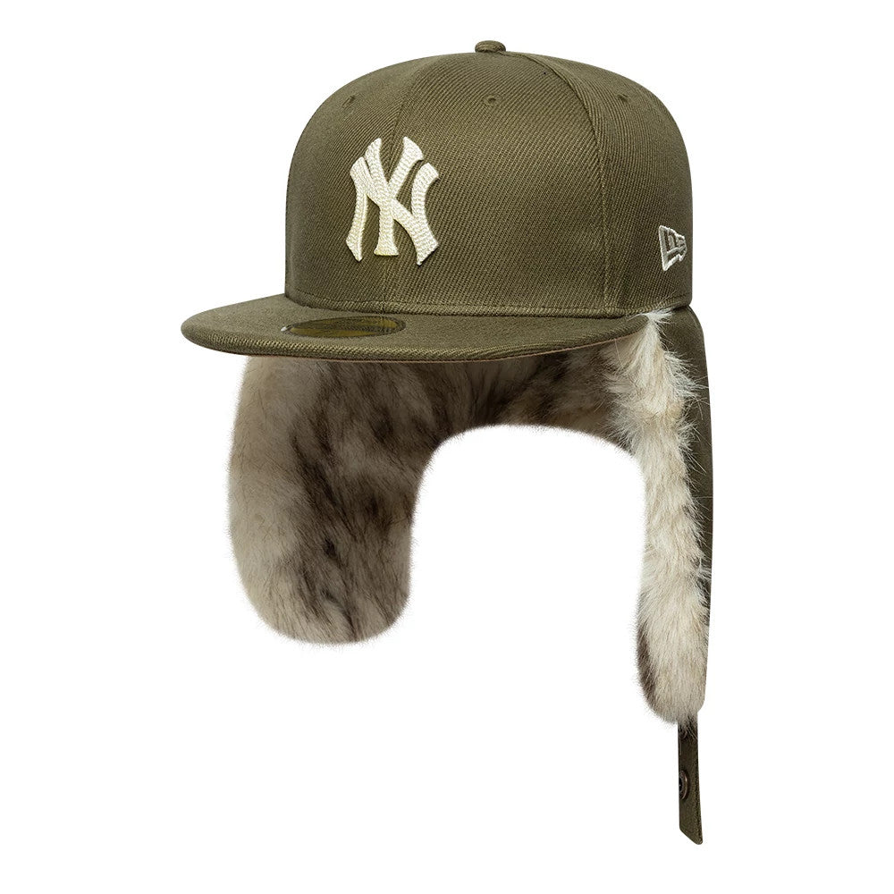 New York Yankees MLB Cotton Canvas Dark Green New Era Dogear 59FIFTY Fitted Cap, three-quarter view with the raised white NY logo on the front panel, dark green flat visor with gold 59FIFTY size sticker, and fur-lined ear flaps extending down.