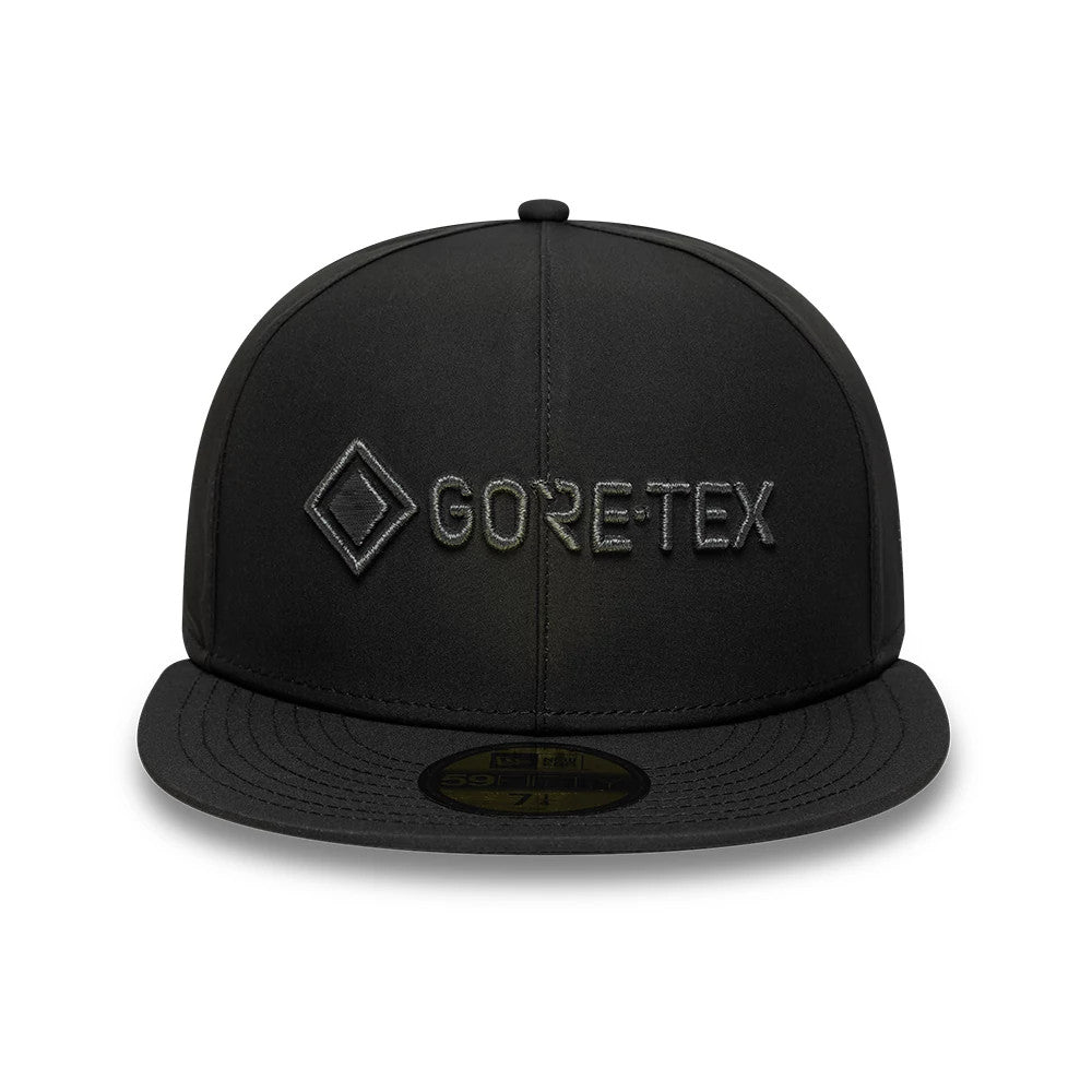 New Era X Gore-Tex Black New Era 59FIFTY Fitted Cap, front view showing the black embroidered Gore-Tex logo on the structured front panels, a flat black visor, and a gold 59FIFTY size sticker on the visor.