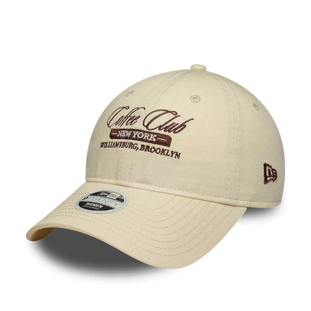 Womens New Era Café Slogan Cream 9TWENTY Adjustable Cap, front view showing brown embroidered Coffee Club New York Williamsburg, Brooklyn on the cream front panel, with a curved visor and a New Era flag logo on the left side.
