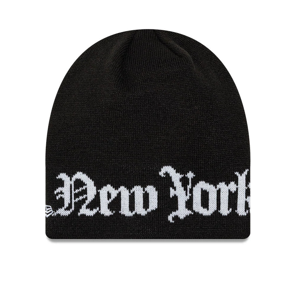 New Era New York Yankees MLB Script Black Skull Knit Beanie Hat, front view showing the white embroidered New York text across the front, with a black knit texture and the New Era flag logo placed on the left side.
