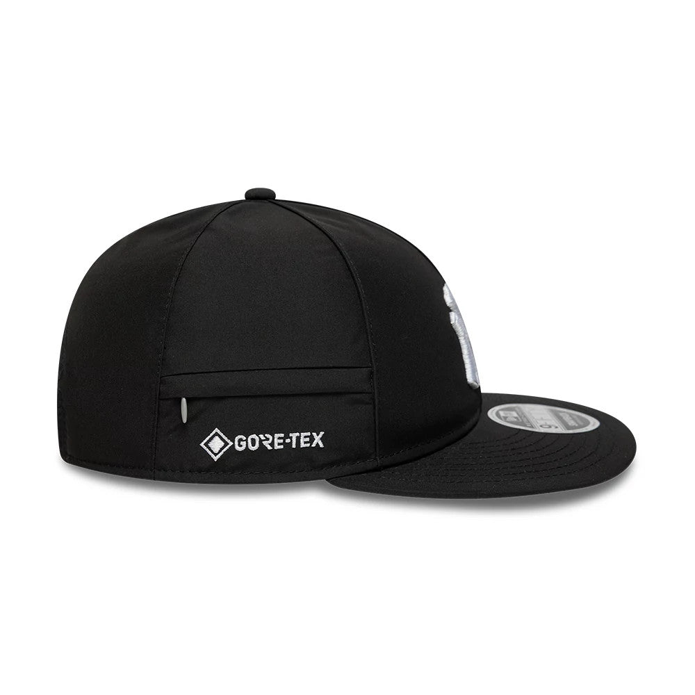New York Yankees MLB X Gore-Tex Black Retro Crown New Era 9FIFTY Adjustable Cap, side view showing the white embroidered Gore-Tex logo on the black crown, along with a flat black visor featuring a 9FIFTY size sticker on top.