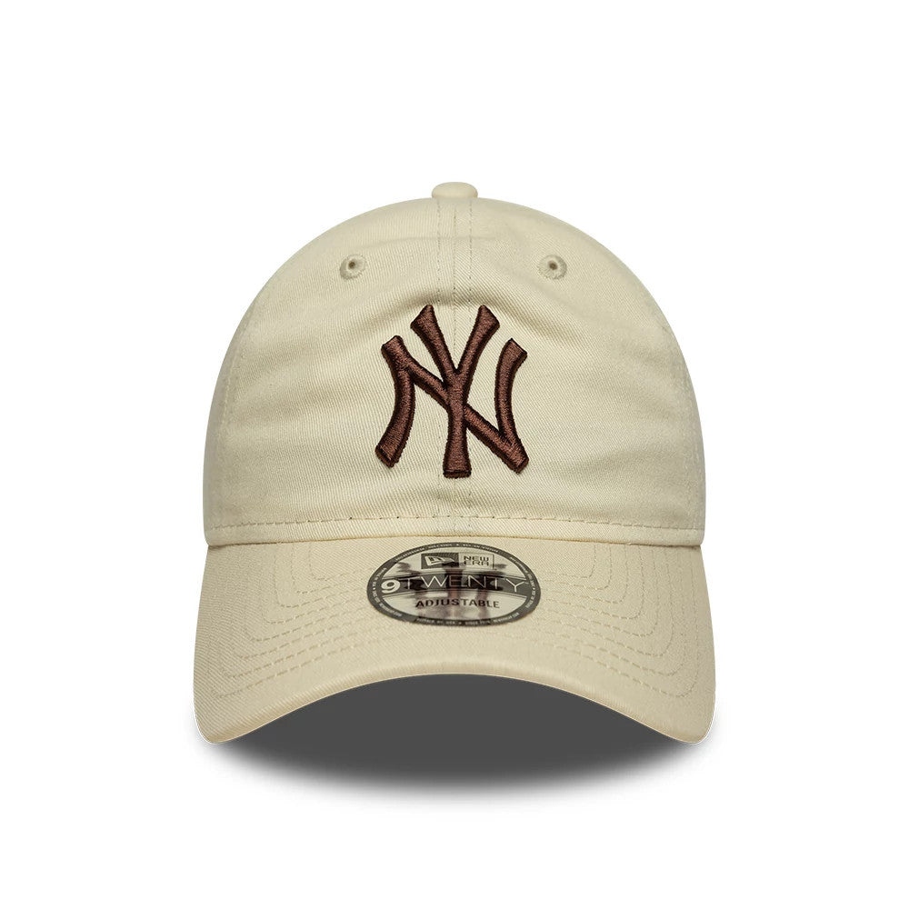 New York Yankees MLB League Essential Cream New Era 9TWENTY Adjustable Cap, front view showing the raised brown embroidered NY logo on the cream front panel, with a curved visor and the 9TWENTY size sticker on the visor.