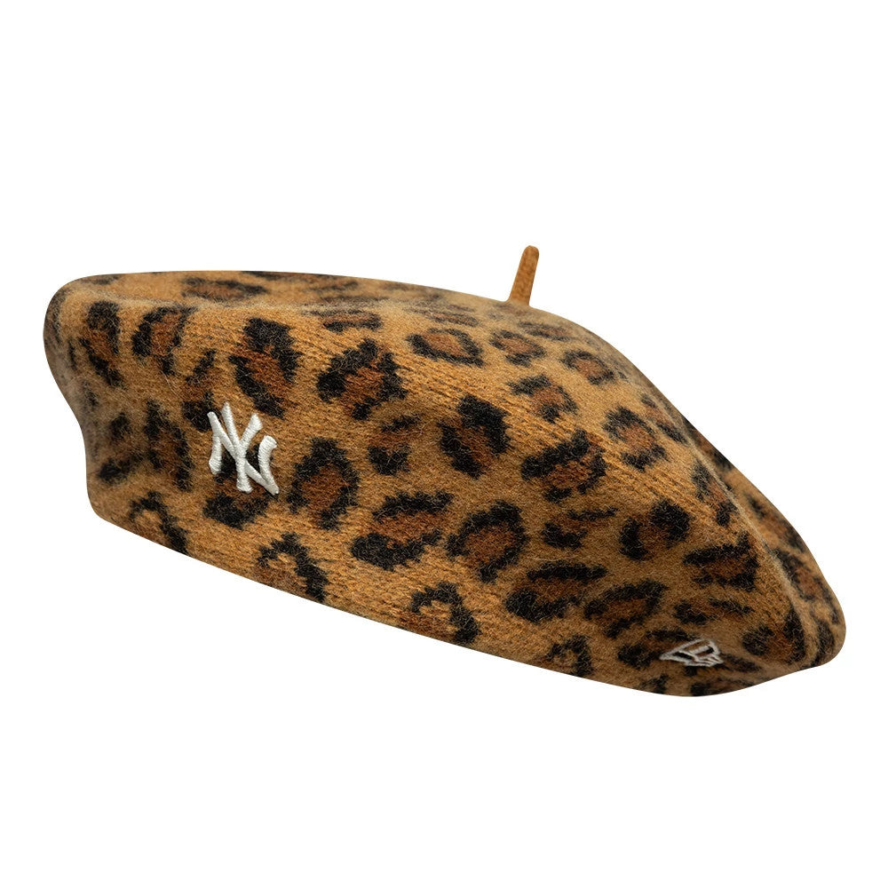 New Era New York Yankees MLB Leopard Beige Beret, side view showing a beige and brown leopard print pattern with a prominent white embroidered NY logo on the left, alongside the New Era flag logo, adding a touch to the classic beret design.