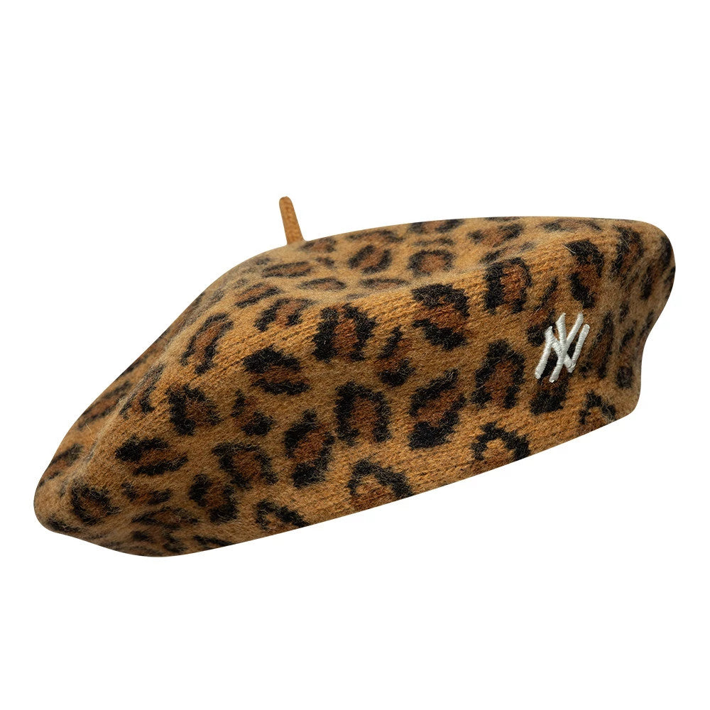 New Era New York Yankees MLB Leopard Beige Beret, front three-quarter view showing the beige leopard print pattern across the entire beret, the white embroidered NY logo on the side, and the small top nub in matching fabric.