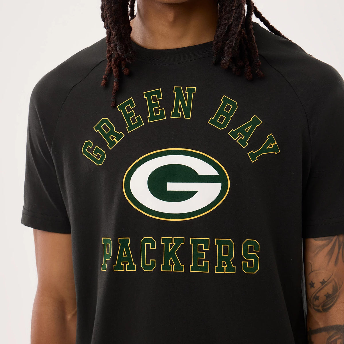 New Era Green Bay Packers NFL Sideline 2026 Black T-Shirt, front view displaying the printed Green Bay lettering arching above the team's green and white G logo on the chest, with Packers text below on a model.