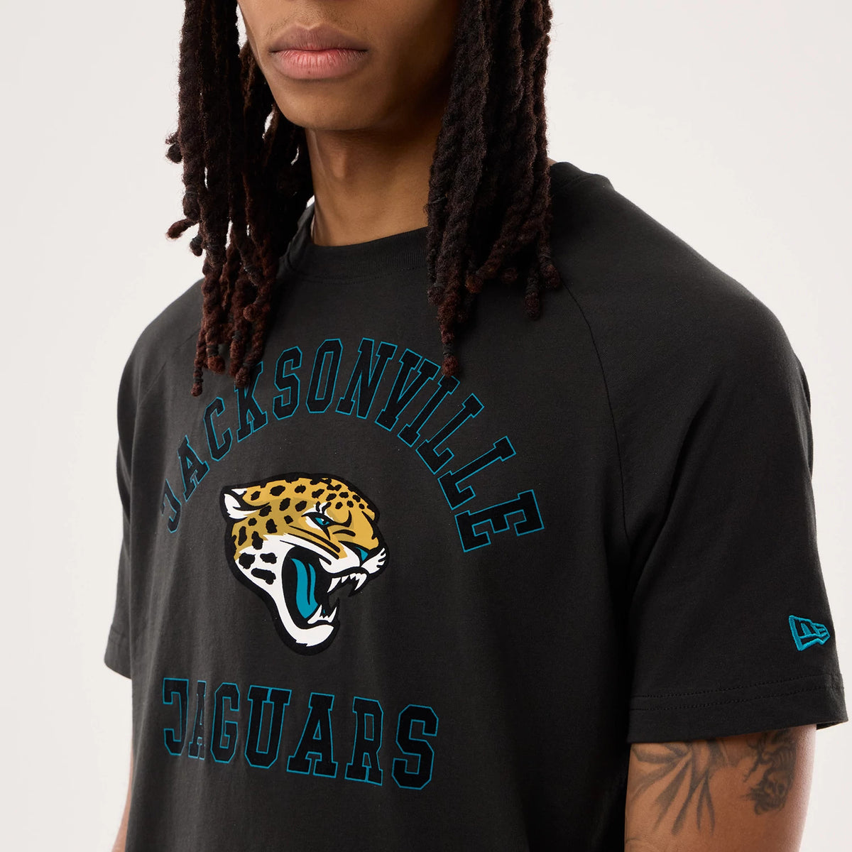 New Era Jacksonville Jaguars NFL Sideline 2026 Black T-Shirt, front view on-model showing the jaguar head logo prominently in the centre beneath arched Jacksonville text, with a small New Era embroidered logo on the left sleeve.
