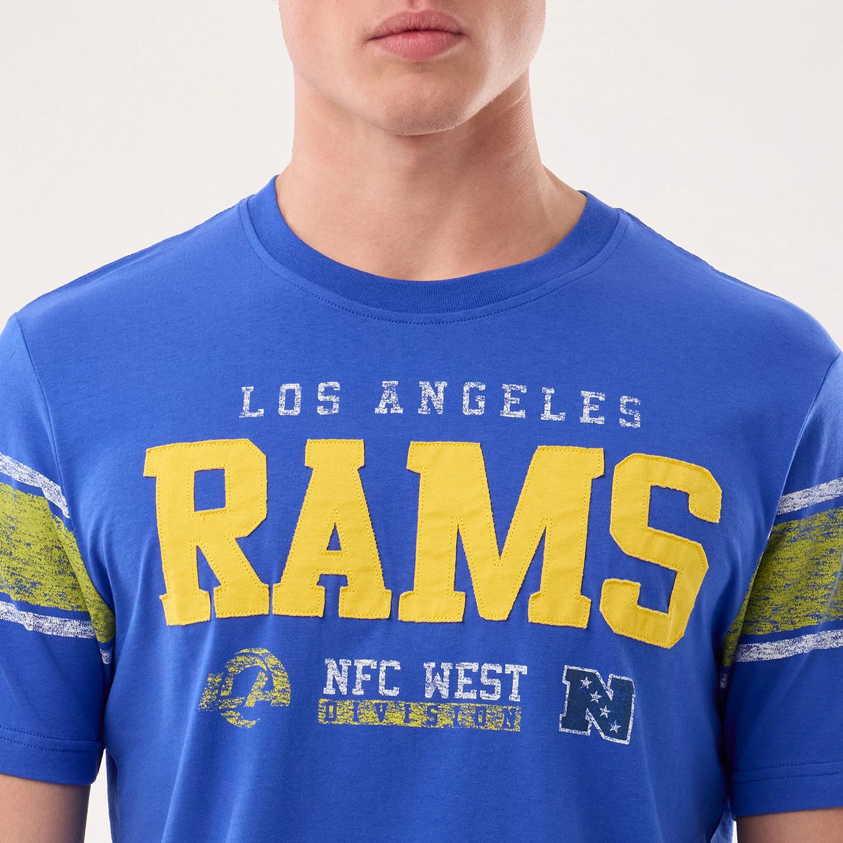 New Era LA Rams NFL Sideline 2026 Bright Blue T-Shirt, front view showing yellow RAMS lettering across the chest with distressed white LOS ANGELES text above, additional graphic elements and yellow accented stripes on the sleeves.