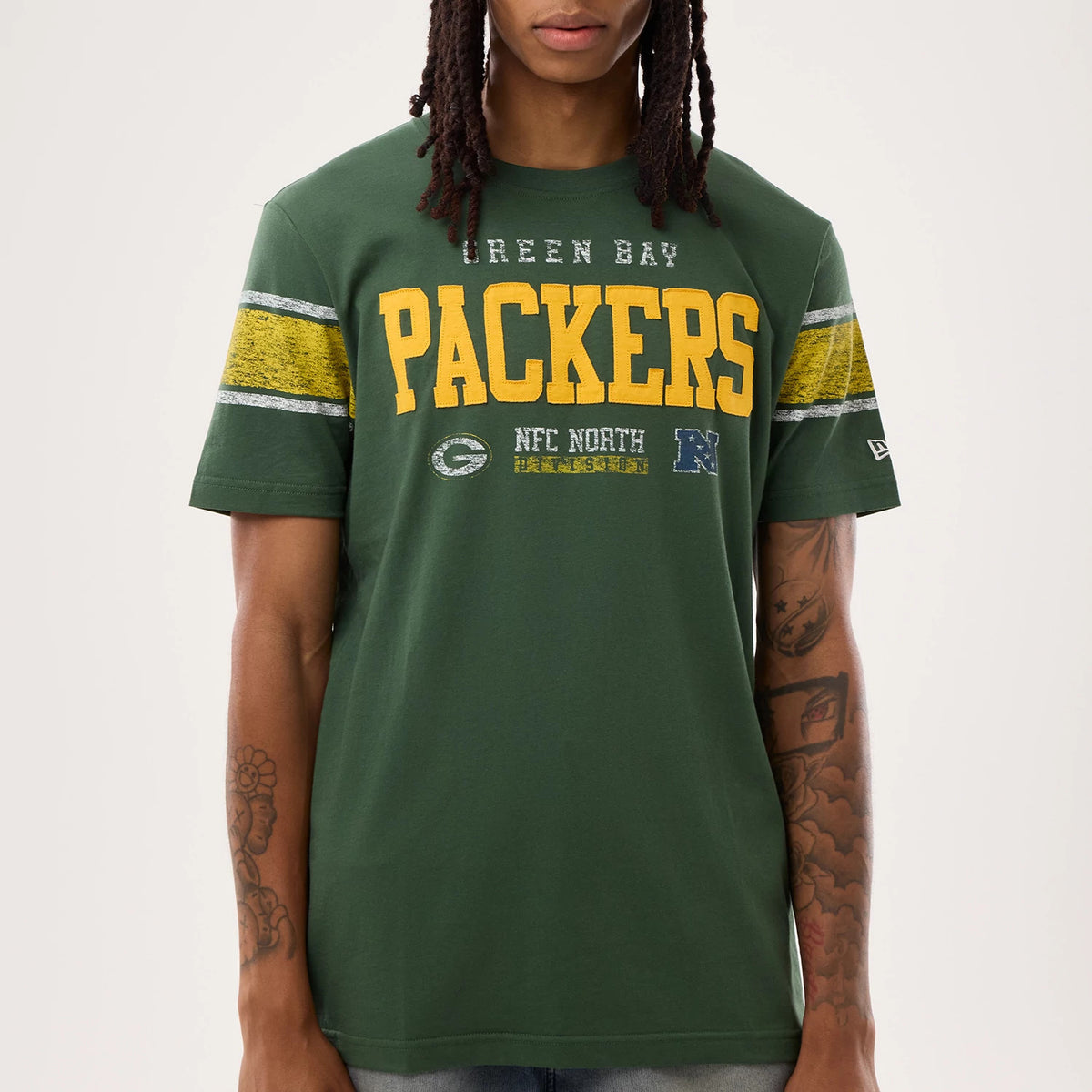 New Era Green Bay Packers NFL Sideline 2026 Dark Green T-Shirt, front view on-model highlighting large yellow Packers lettering across the chest with Green Bay wording above, and stripes on the sleeves.