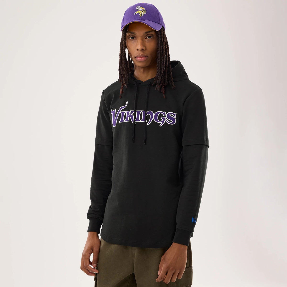 The model is wearing this NFL Sideline 2026 Minnesota Vikings Double Sleeve Hoodie in black. 1