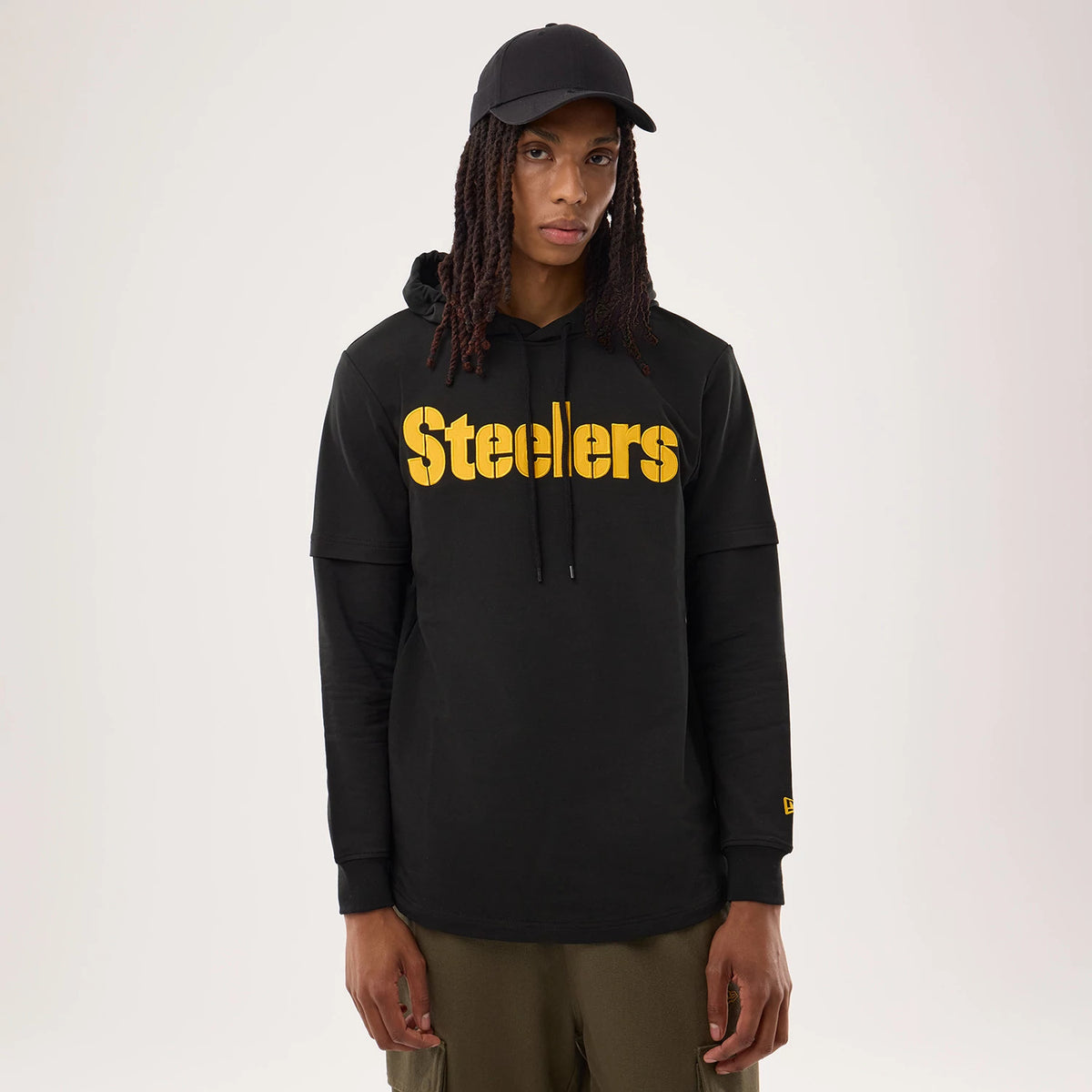 New Era Pittsburgh Steelers NFL Sideline 2026 Black Double Sleeve Hoodie, front view on-model featuring yellow Steelers wordmark across the chest, a double sleeve design with a embroidered New Era logo on the left cuff, and an attached hood.