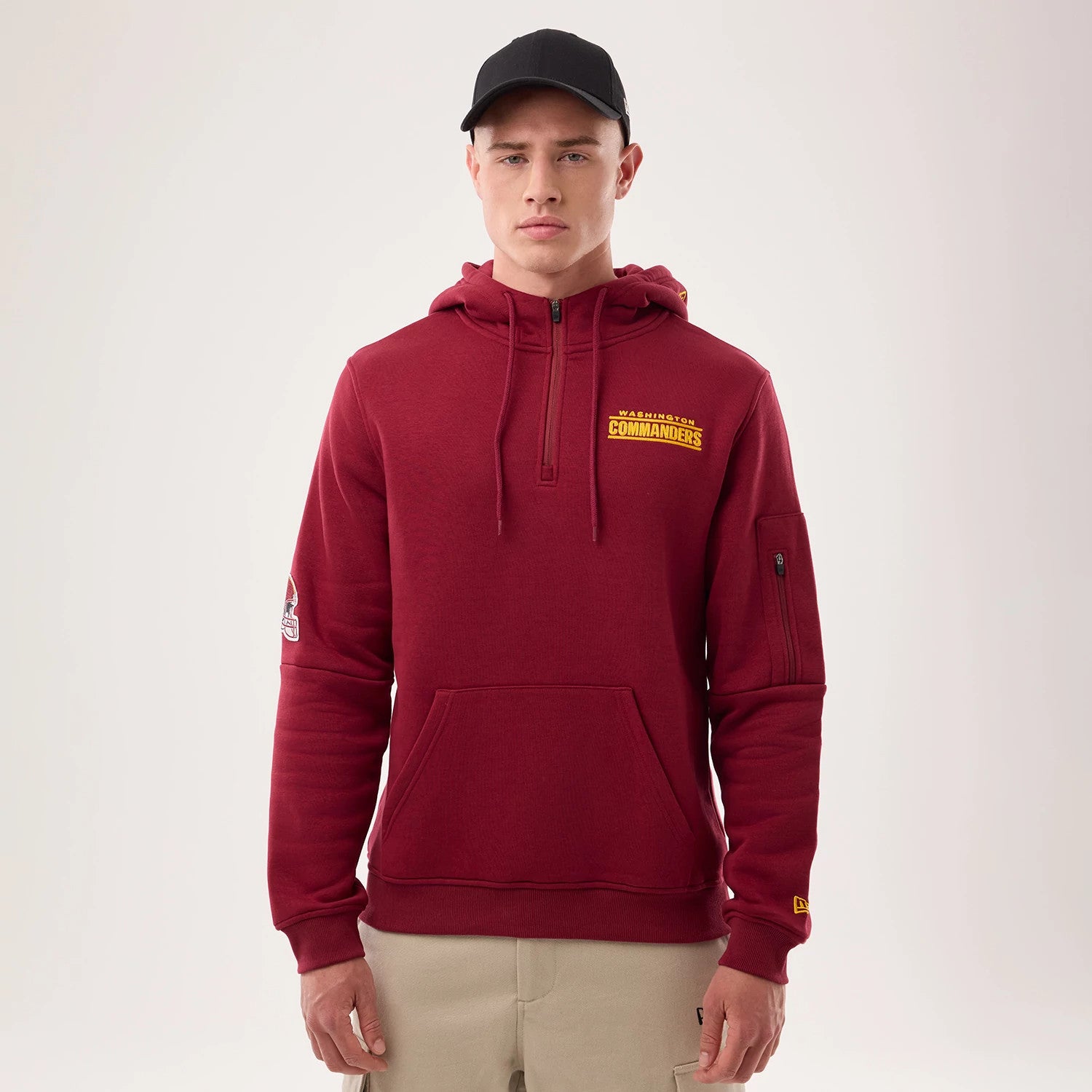 The model is wearing this NFL Sideline 2026 Washington Commanders Pullover Hoodie in dark red. 1