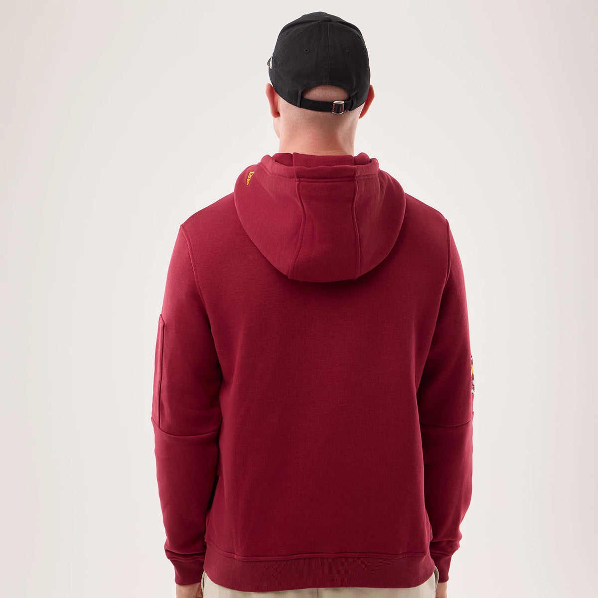 The model is wearing this NFL Sideline 2026 Washington Commanders Pullover Hoodie in dark red. 2