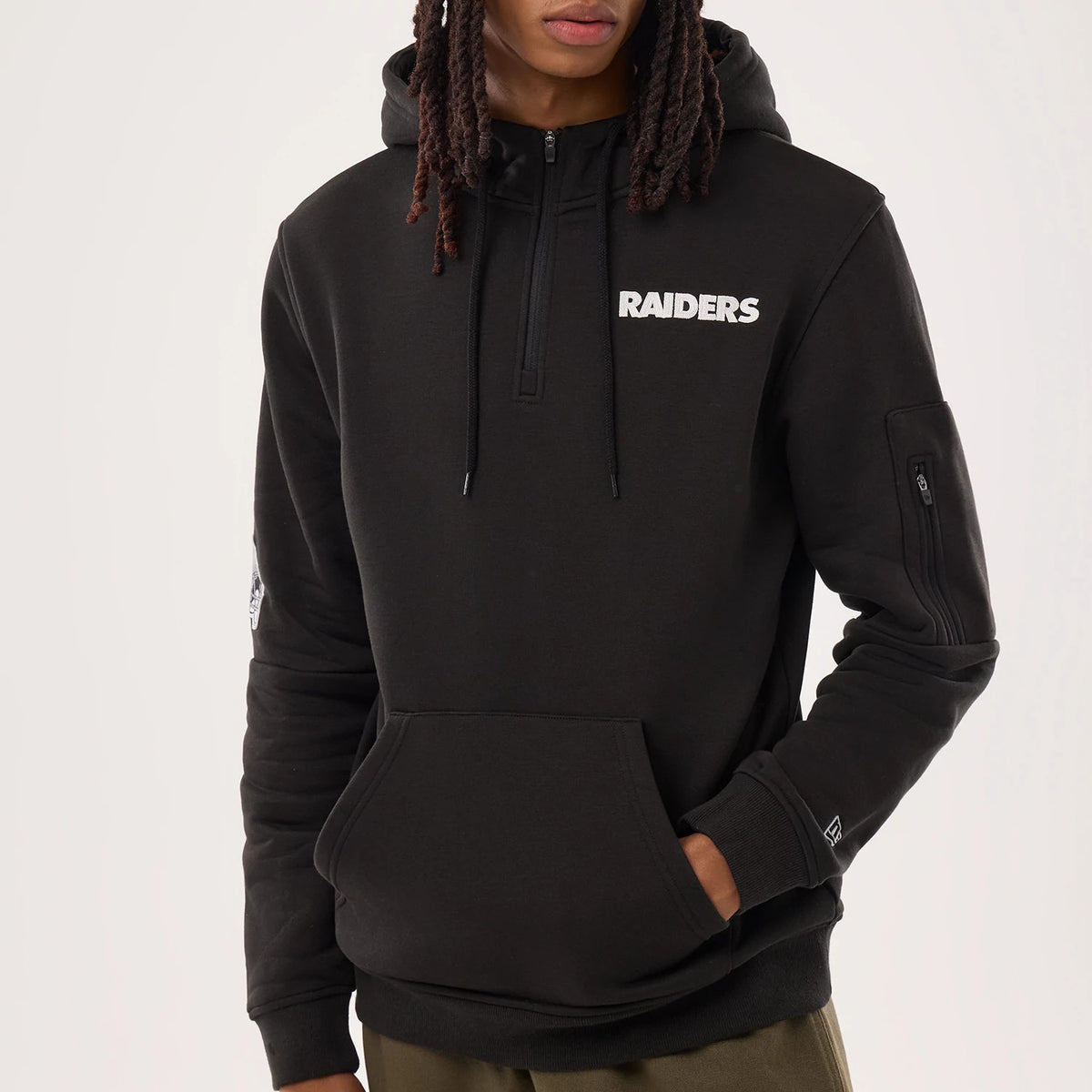 The model is wearing this NFL Sideline 2026 Las Vegas Raiders Pullover Hoodie in black. 3
