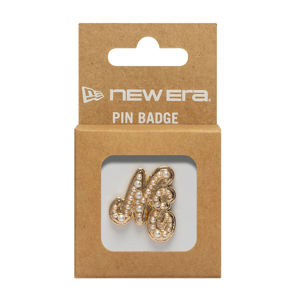 New Era Faux Pearl Gold Pin Badge, front view showing a decorative NE in gold with faux pearl embellishments in a clear box, a printed New Era logo and PIN BADGE wording on the brown cardboard packaging above.