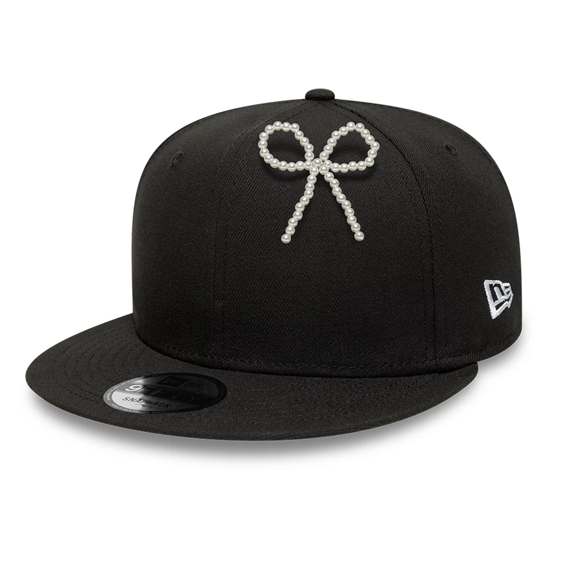 Pictured is this New Era Faux Pearl Bow Pin Badge in White. 2