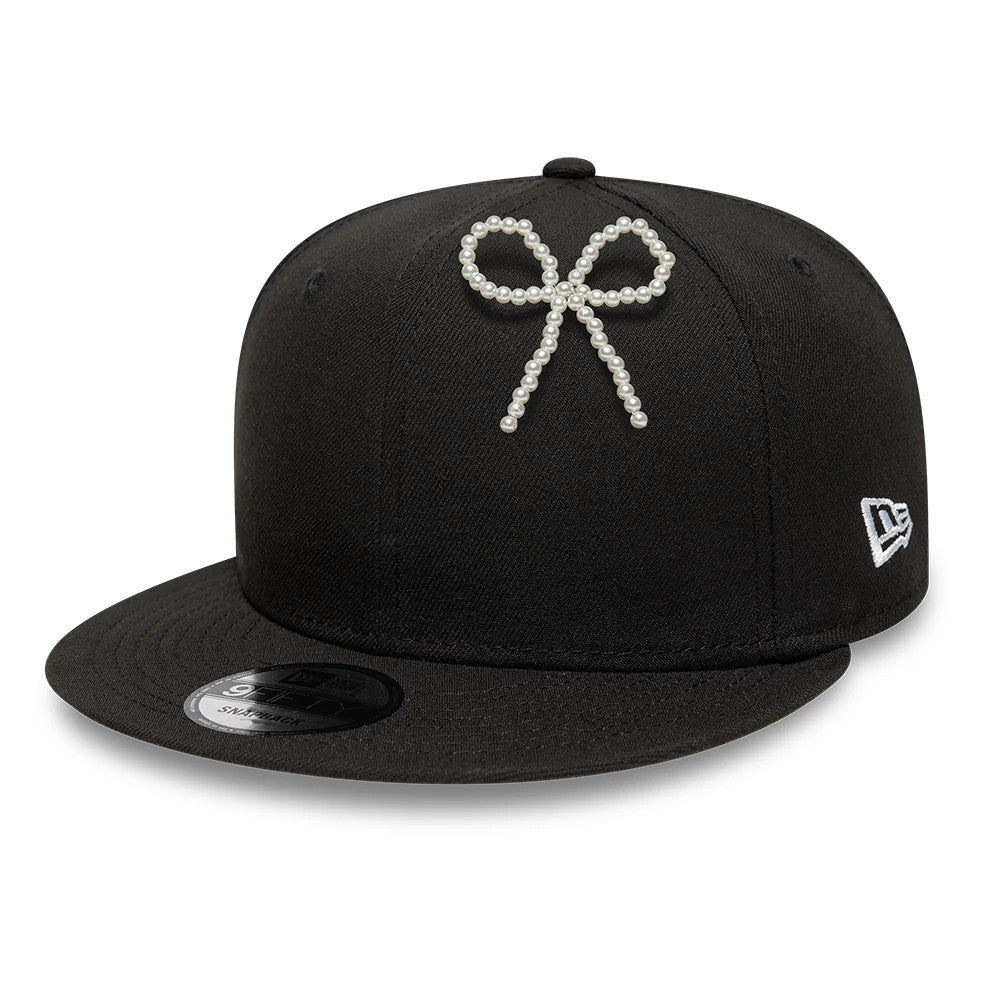 Pictured is this New Era Faux Pearl Bow Pin Badge in White. 2