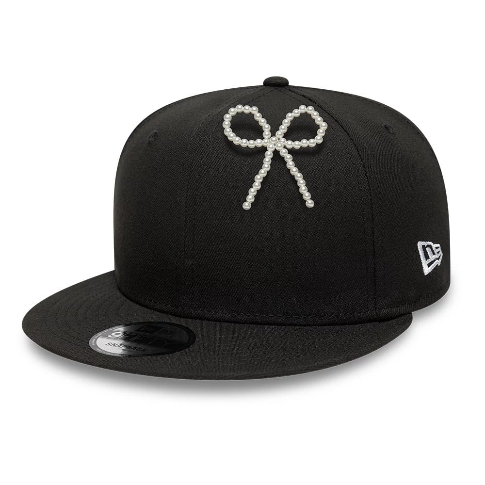 Pictured is this New Era Faux Pearl Bow Pin Badge in White. 2