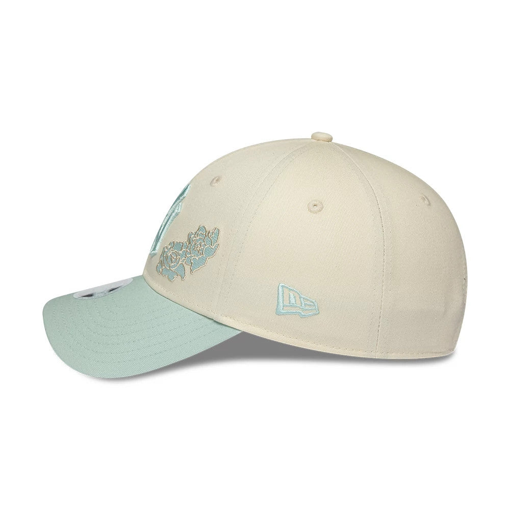 New York Yankees Womens MLB Floral Cream New Era 9FORTY Adjustable Cap, side view showing the teal embroidered New Era flag logo on the left side, structured cream crown with teal floral design.