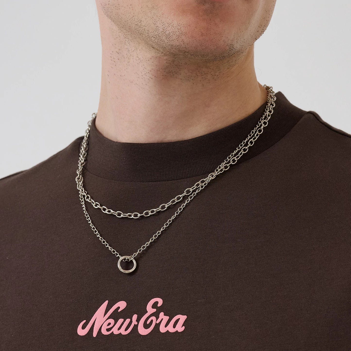 The model is wearing this New Era Love Graphic T-Shirt in dark brown. 6