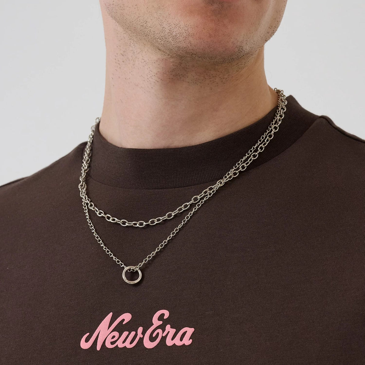 The model is wearing this New Era Love Graphic T-Shirt in dark brown. 6