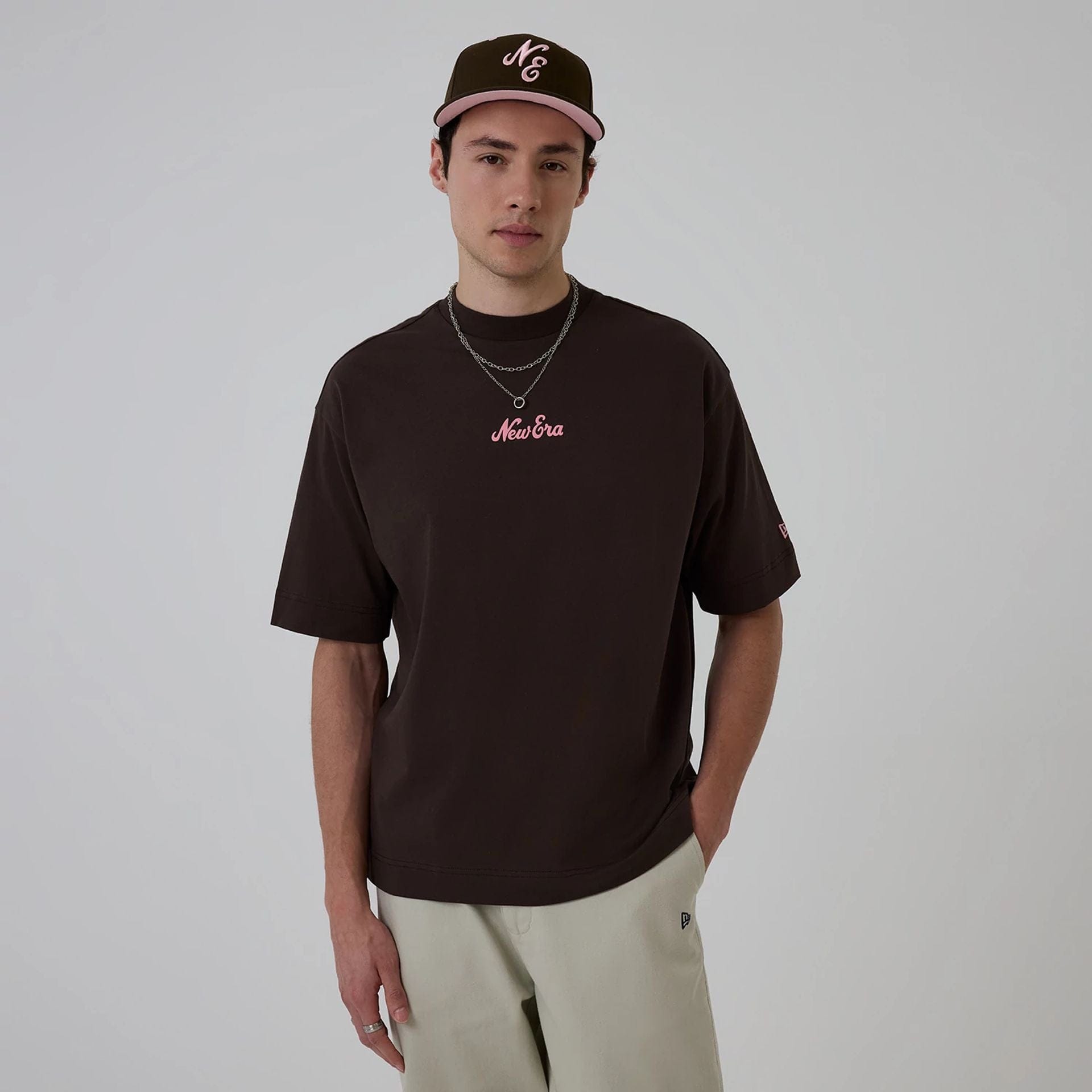 The model is wearing this New Era Love Graphic T-Shirt in dark brown. 1