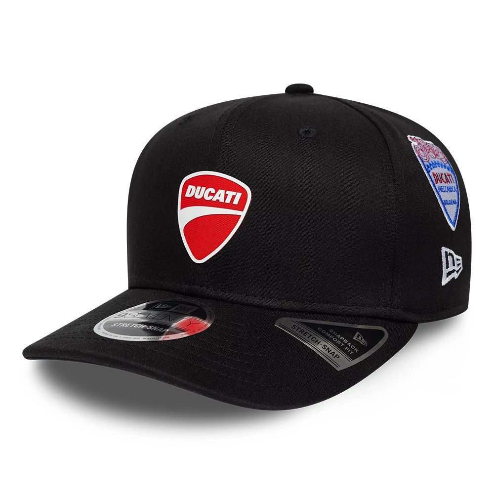 Ducati Motor Logo Patch Black New Era 9SEVENTY Stretch Snap Adjustable Cap, three-quarter view showing the red and white embroidered Ducati patch on the front panel, a woven patch on the right, and a New Era flag logo on the left side.