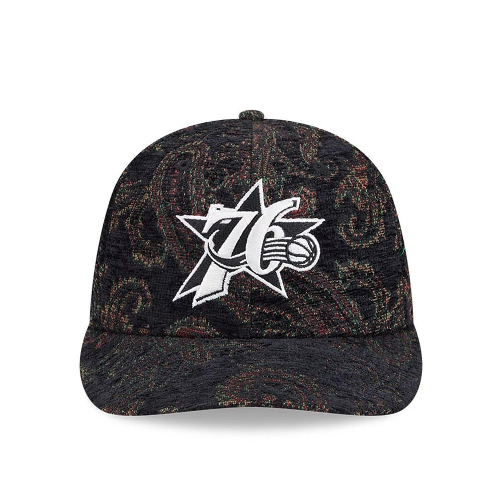 Philadelphia 76ers NBA Jacquard Chenille Black New Era 59FIFTY Fitted Cap, front view showing the prominent white embroidered 76ers logo on the structured black crown with a multi-coloured paisley pattern and a matching black curved visor.
