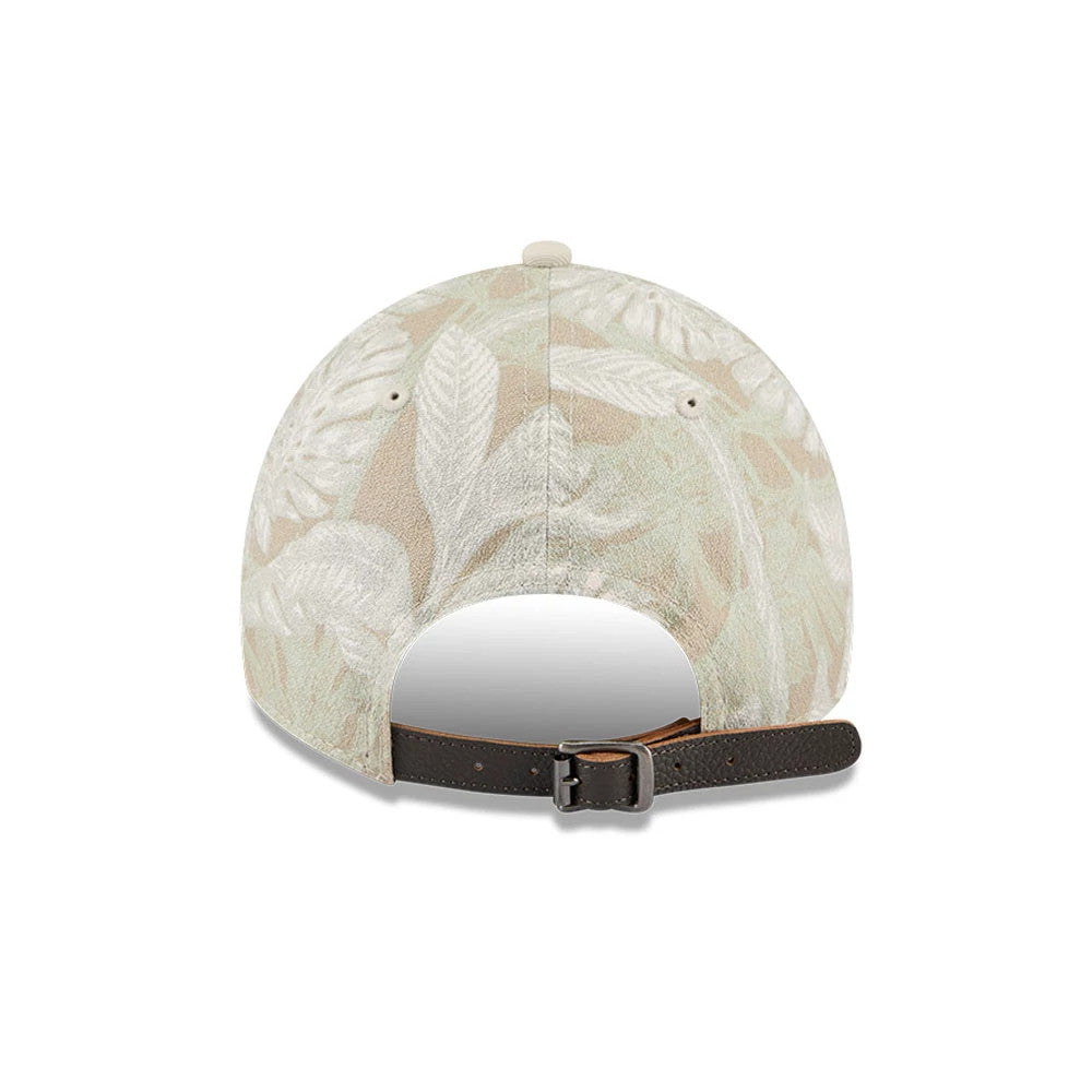 New Era Leafy Palm Light Beige 9TWENTY Adjustable Cap, rear view showing a detailed leaf pattern in beige and light colours on the unstructured crown, with a brown leather strap and buckle for adjustment at the back.