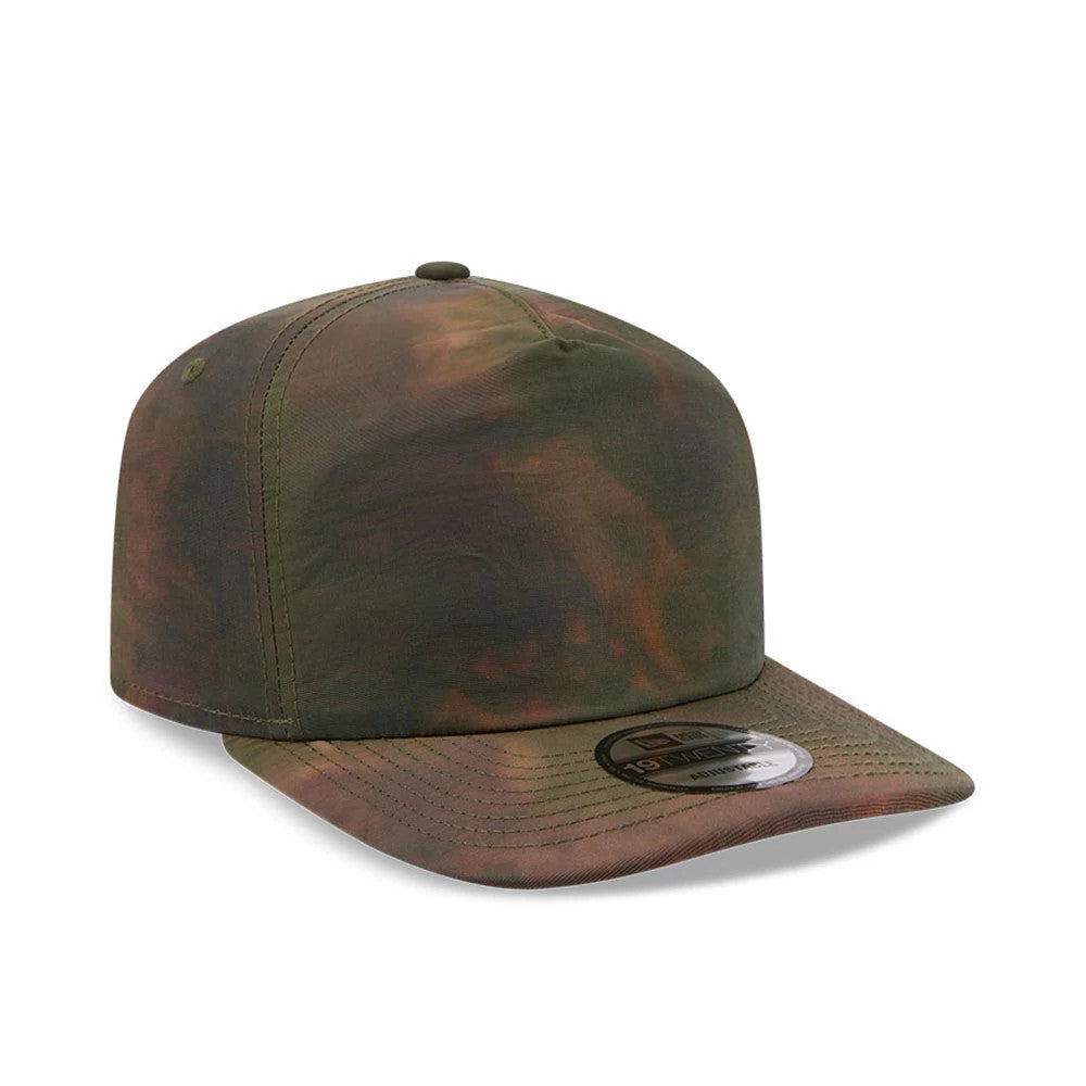 New Era Nylon Wash Dye Open Green 19TWENTY Adjustable Cap, three-quarter view showing the muted green and brown wash dye pattern on the cotton crown, a curved visor with stitching, and a 19TWENTY size sticker on the visor.