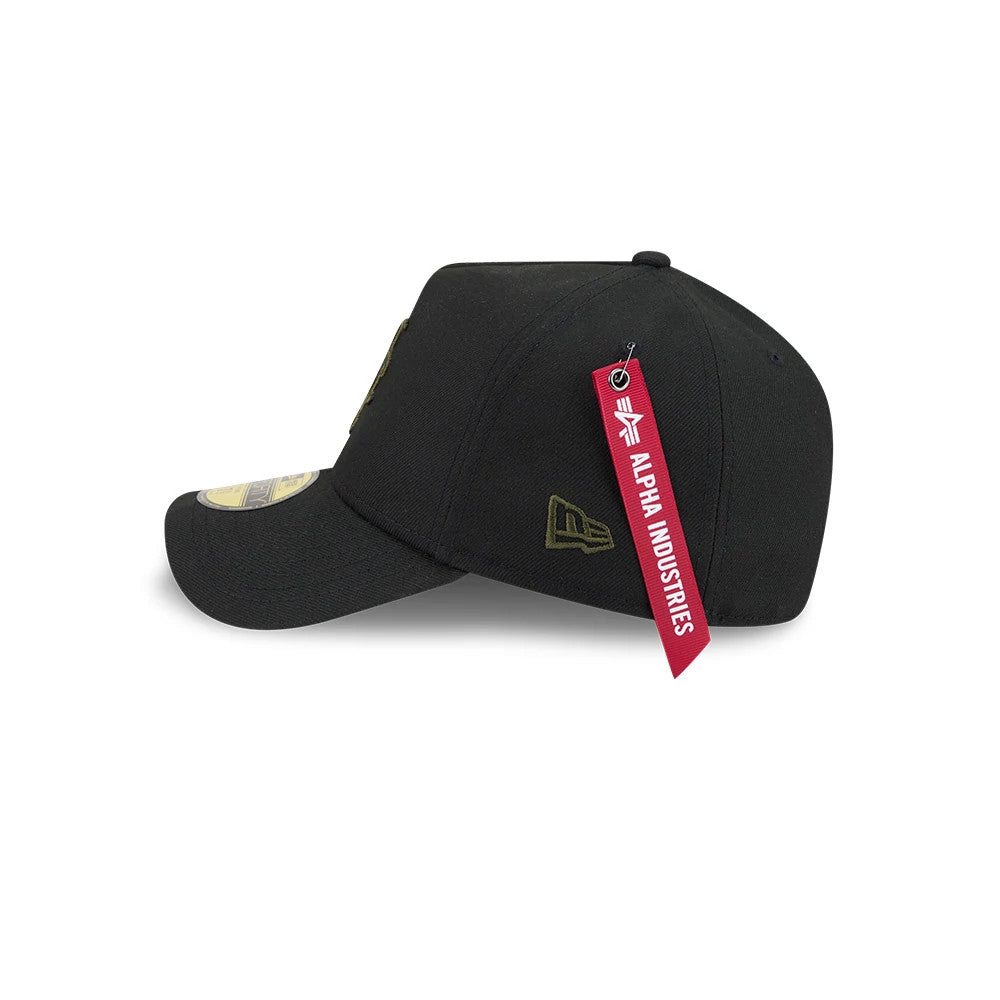New York Mets MLB X Alpha Black New Era 59FORTY A-Frame Fitted Cap, side view showing the gold embroidered New Era flag logo on the left side, with a curved black visor and a prominent Alpha Industries red tag attached.