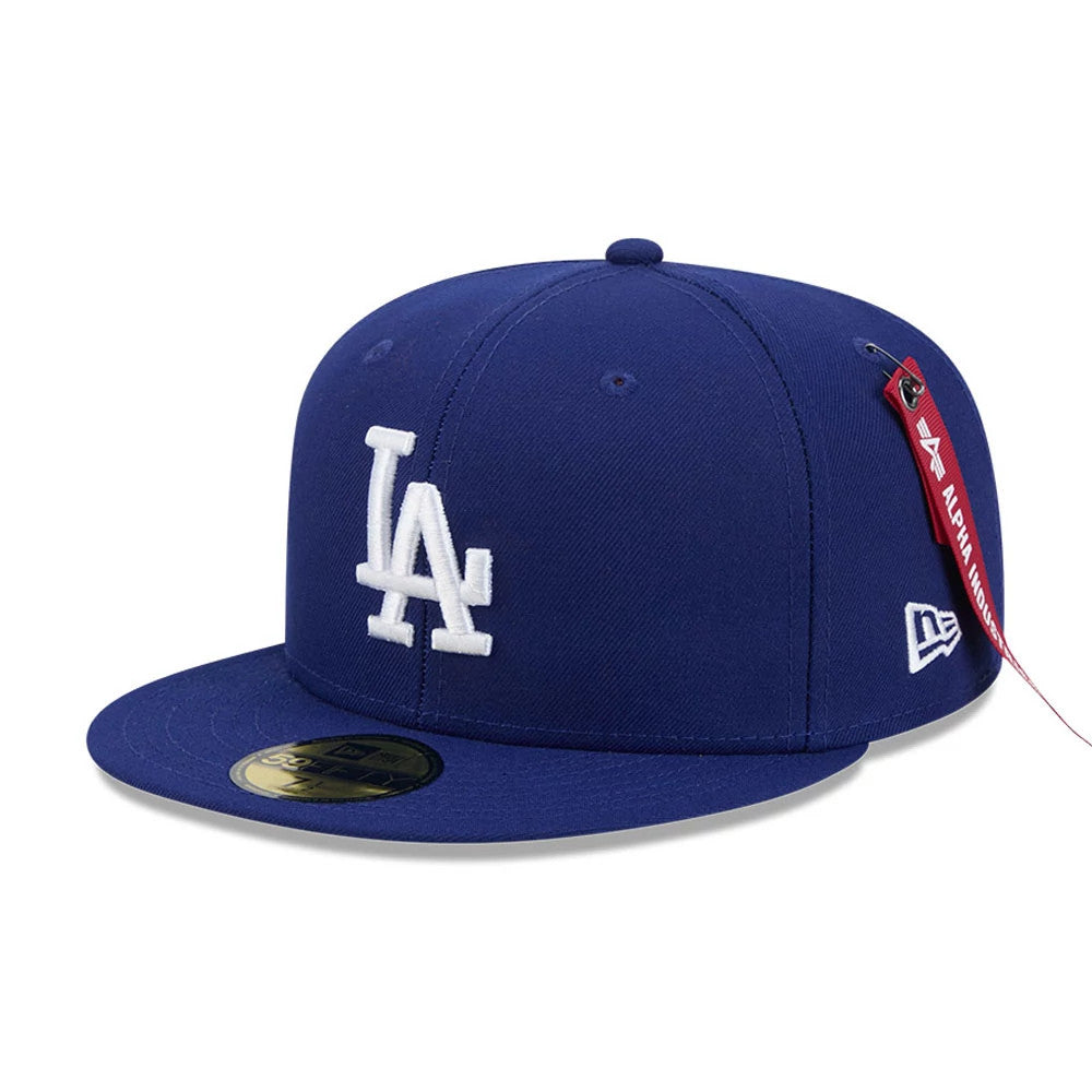 LA Dodgers MLB X Alpha Navy New Era 59FIFTY Fitted Cap, three-quarter view showing a white raised embroidered LA logo on the front panel, navy flat visor with a gold 59FIFTY size sticker, and a New Era flag logo on the left side.