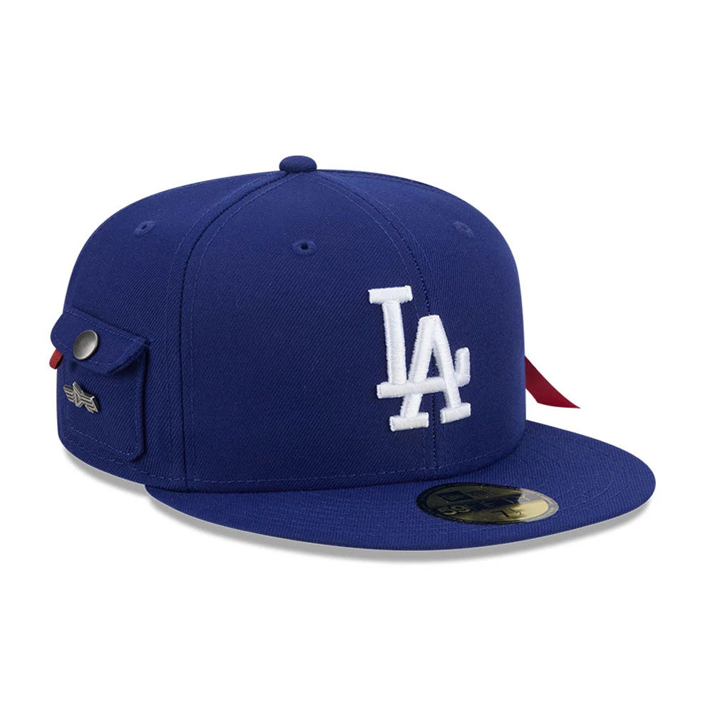 LA Dodgers MLB X Alpha Navy New Era 59FIFTY Fitted Cap, three-quarter view showing the white embroidered LA logo on the front panel, a flat navy visor with a gold 59FIFTY size sticker, and a side pocket with a button.