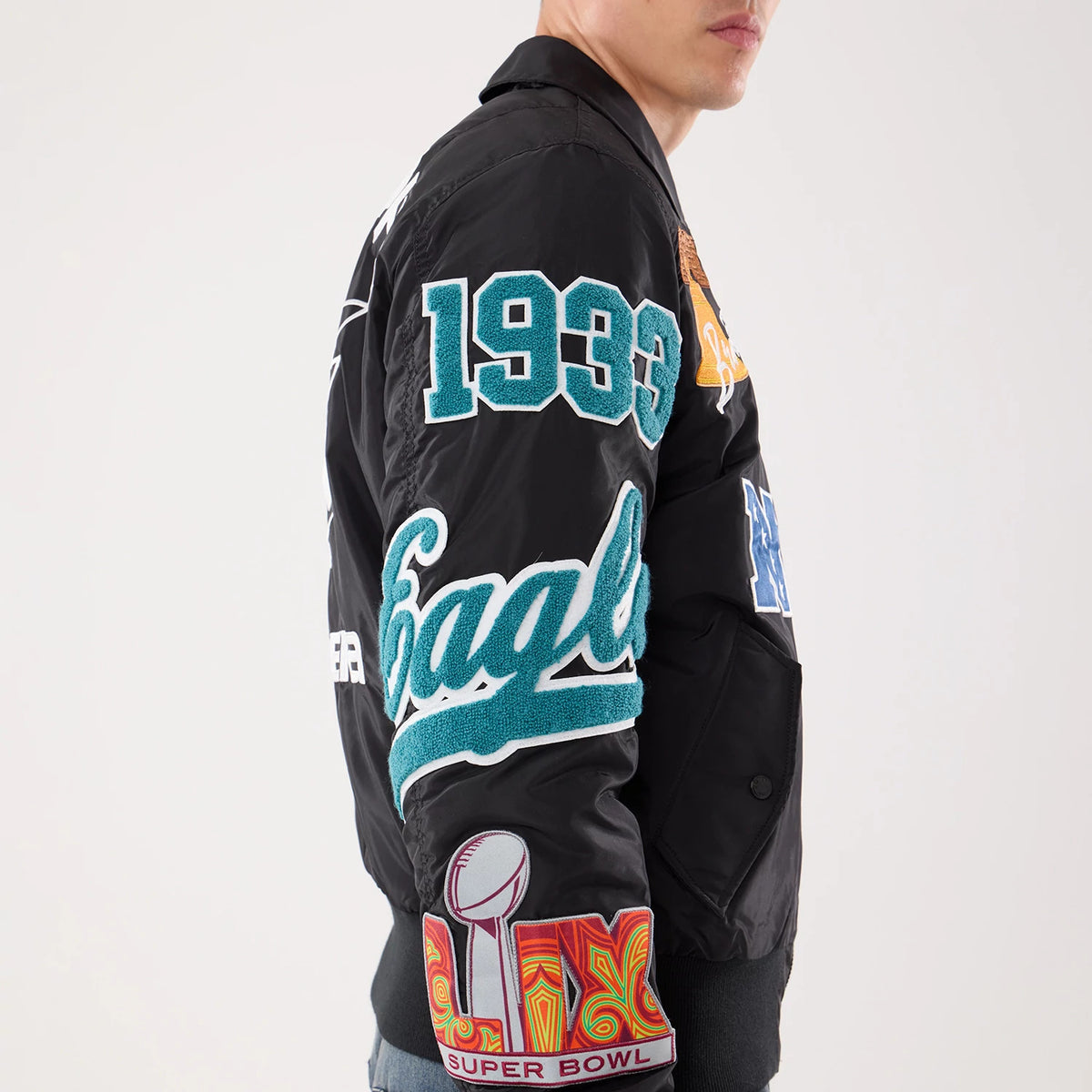 The model is wearing this NFL X Alpha Philadelphia Eagles Jacket in Black. 4