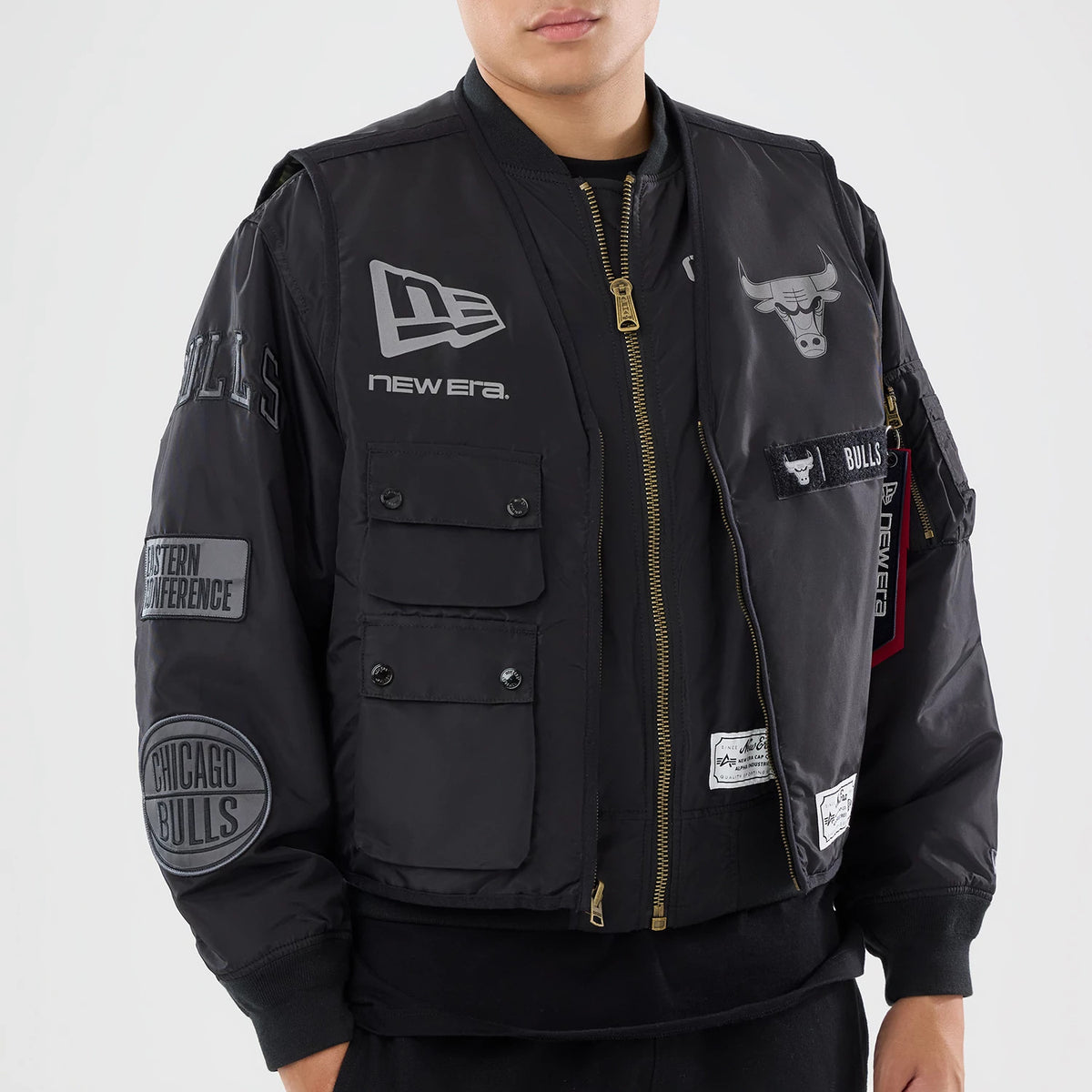The model is wearing this NBA X Alpha Chicago Bulls Bomber Jacket & Tactical Vest in black. 4