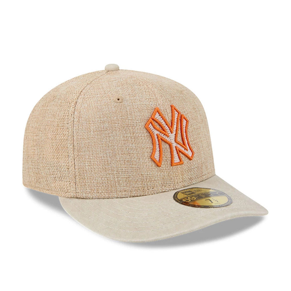 New York Yankees MLB Halloween Beige New Era 59FIFTY Fitted Cap, three-quarter view showing an orange and white embroidered Yankees logo on the front panel, a beige flat visor, and a gold 59FIFTY size sticker on the visor.