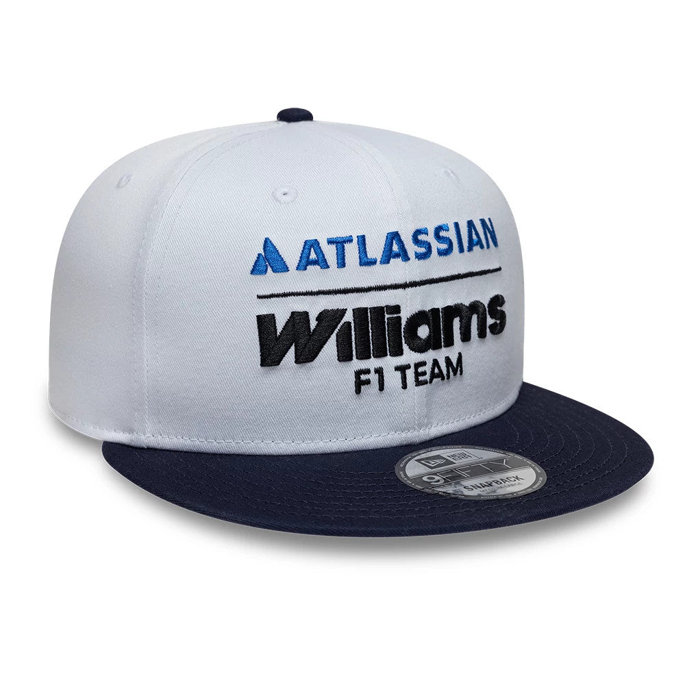 Williams Essential White New Era 9FIFTY Snapback Adjustable Cap, front view showing embroidered blue Atlassian logo and black Williams F1 Team lettering on the structured white crown, with a dark navy flat visor and 9FIFTY size sticker.
