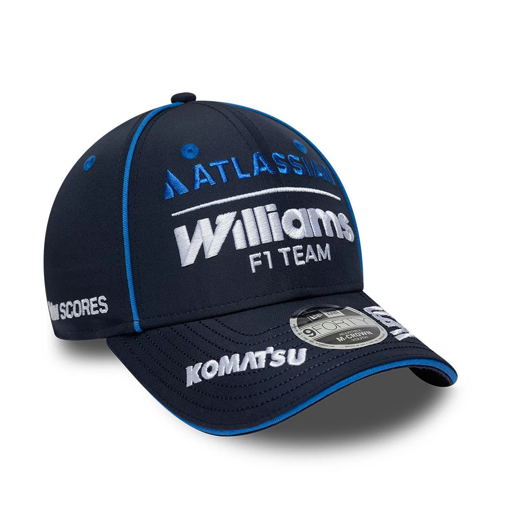 Youth Williams Carlos Sainz Navy New Era 9FORTY M-Crown Adjustable Cap, three-quarter view showing the raised white Williams F1 Team logo on the front panel, contrasting blue eyelets and trimming, and the grey 9FORTY size sticker on the curved visor.