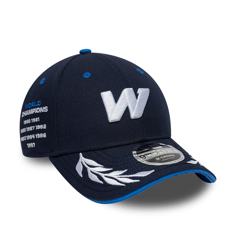 Williams Launch Navy New Era 9FORTY M-Crown Adjustable Cap, three-quarter view showing a raised white W logo embroidered on the front panel, embroidered leaf design on the visor, and a 9FORTY size sticker on the navy visor with blue trim.
