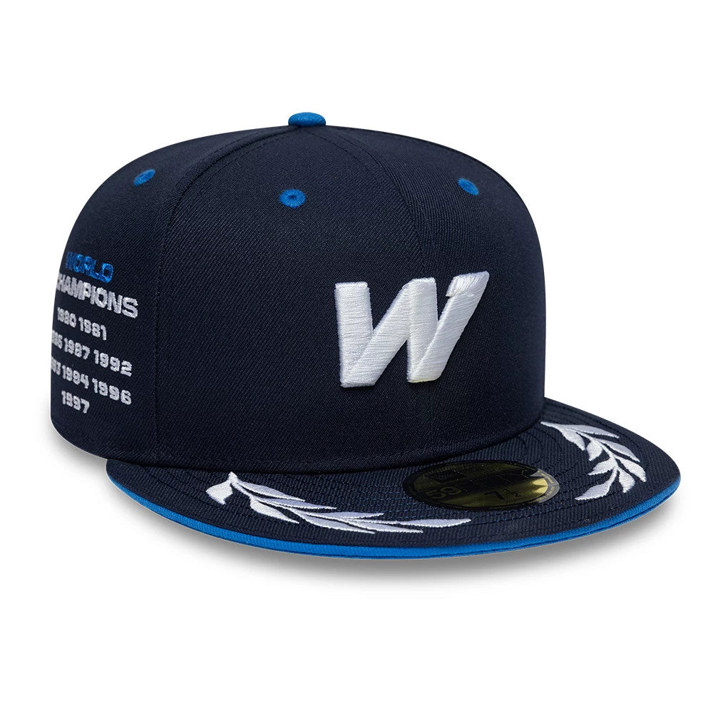Williams Launch Navy New Era 59FIFTY Fitted Cap, three-quarter view showing the large white embroidered W on the front panel, side WORLD CHAMPIONS text with years, and blue-trimmed visor with a gold 59FIFTY size sticker.