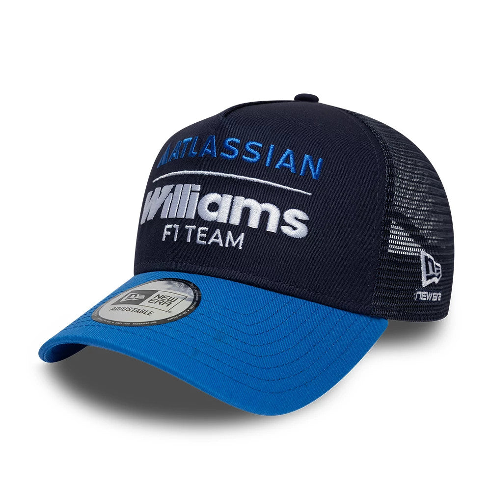 Williams Essential Navy New Era 9FORTY A-Frame Trucker Adjustable Cap, three-quarter view showing the front embroidered Atlassian and Williams F1 Team logos in blue and white, a curved blue visor with a 9FORTY size sticker.